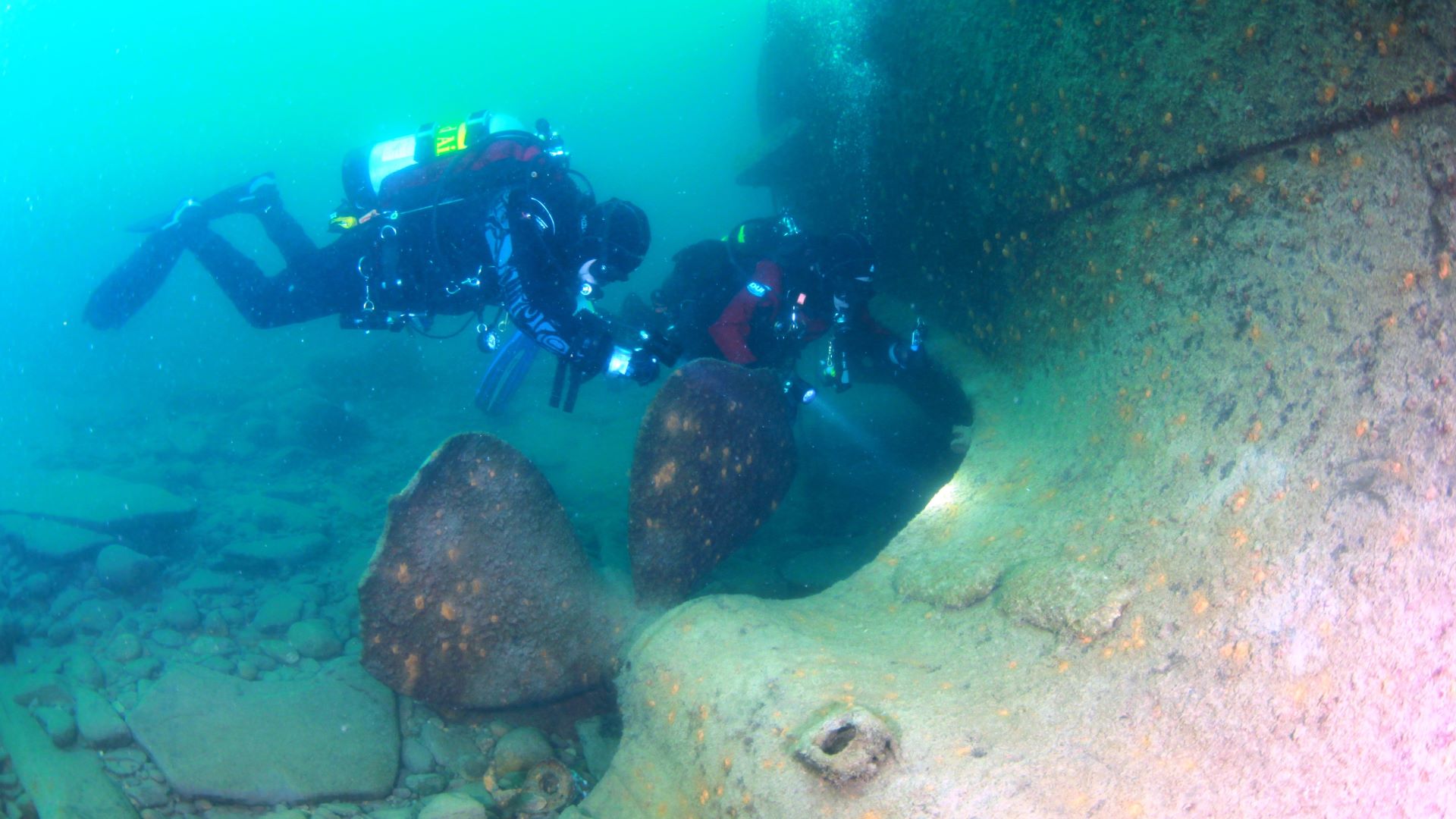 Divers exploring structure on a Great Lakes wreck