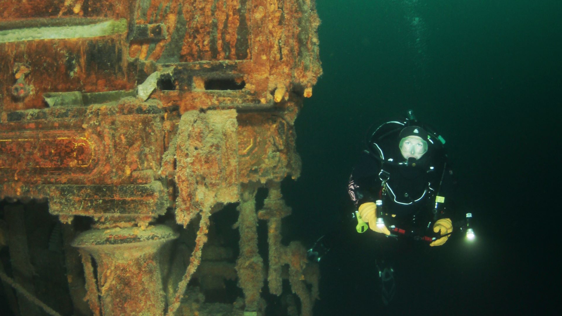 Diver wearing a drysuit preparing for Great Lakes diving