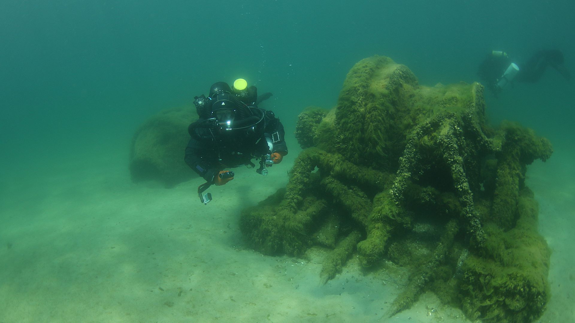 Divers using lights on a Great Lakes wreck dive